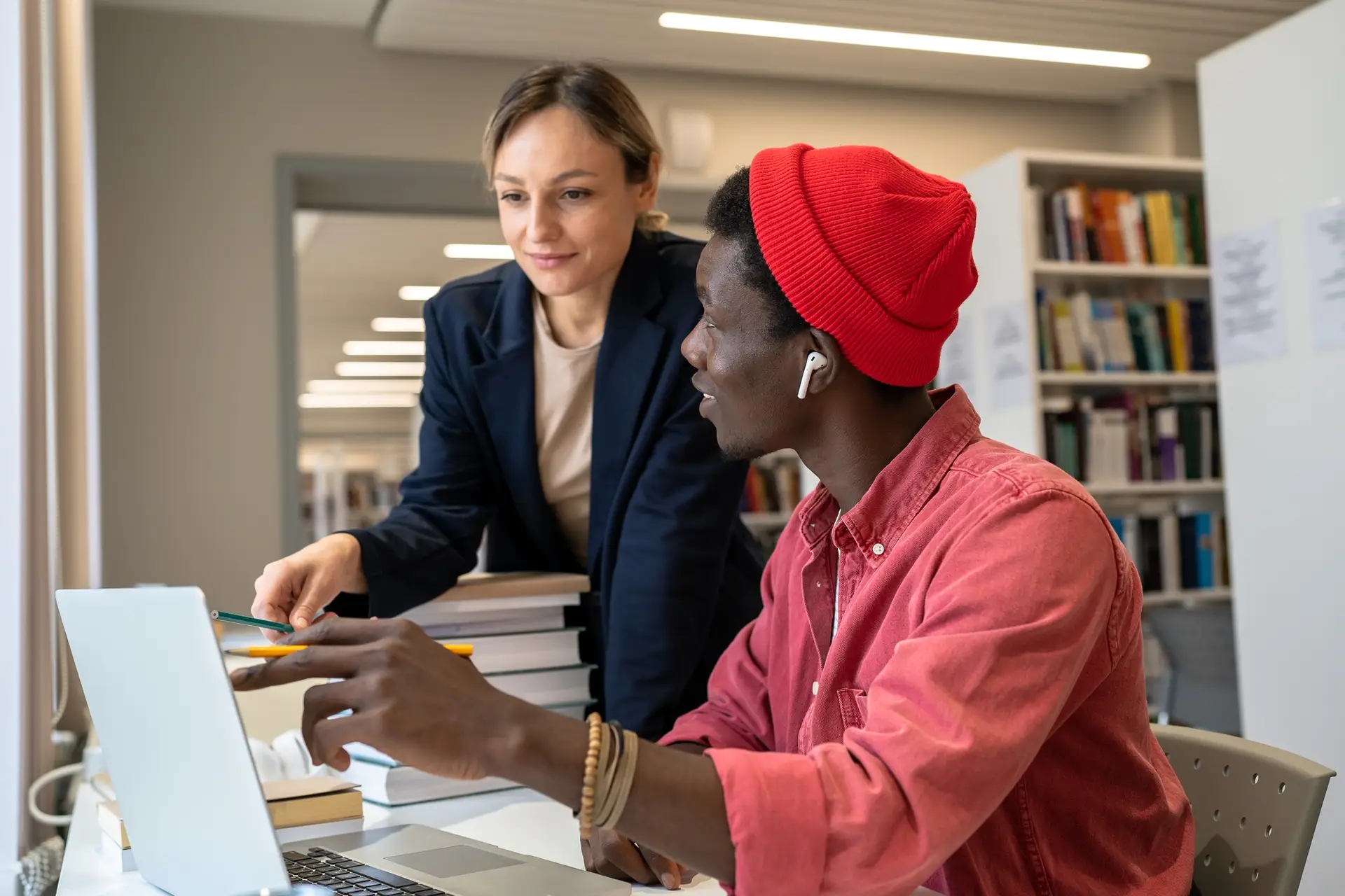 Couple multiethnic pleased students working as team on research project in library for scholarship.